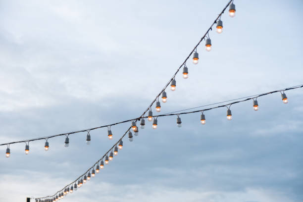 istock Antique light bulbs crossing with hanging on wire 1014687172