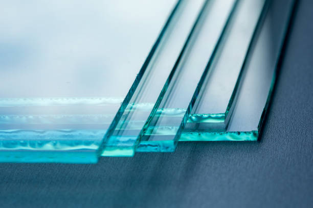 Sheets of Factory manufacturing tempered clear float glass panels cut to size Sheets of Factory manufacturing tempered clear float glass panels cut to size. glass sheet stock pictures, royalty-free photos & images
