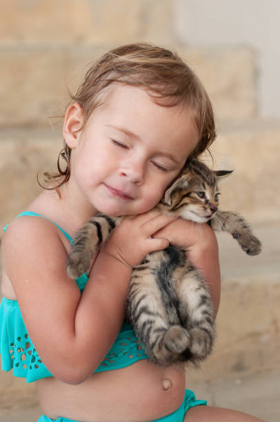 istock young girl holding kitten 1014690938
