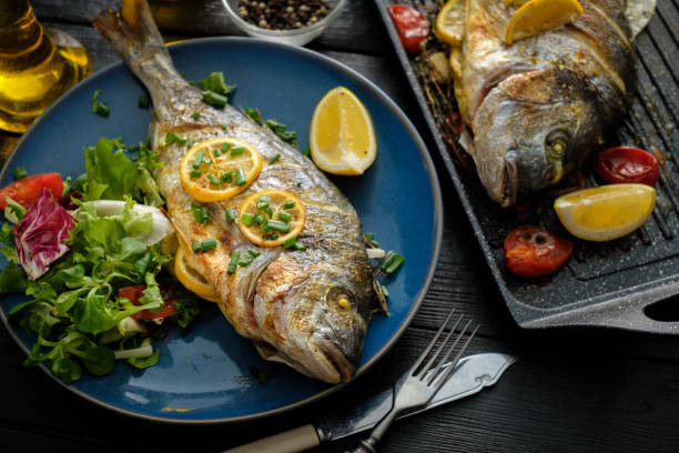 istock Grilled Dorado with lemon, thyme, rosemary and fresh salad 1014697356