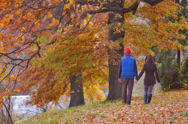 istock Couple in autumn park 1014697666