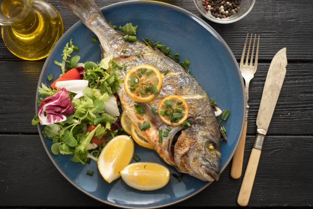 istock Grilled Dorado with lemon, thyme, rosemary and fresh salad 1014697704