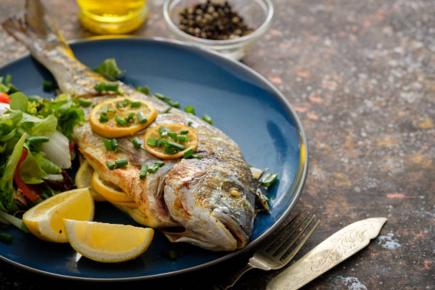 istock Grilled Dorado with lemon, thyme, rosemary and fresh salad 1014703250