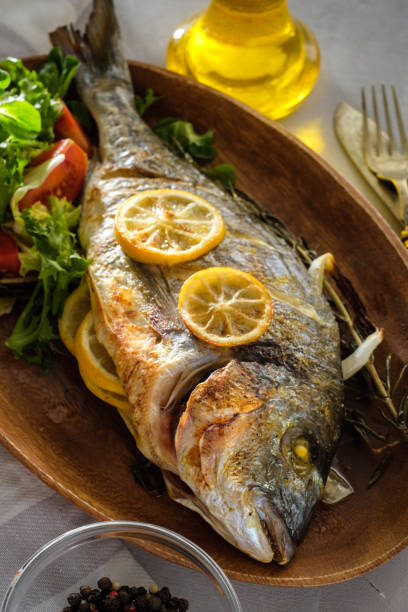 istock Grilled Dorado with lemon, thyme, rosemary and fresh salad 1014703396