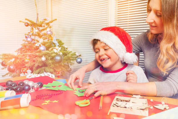 istock Young mom making Christmas ornaments with her son 1014706774