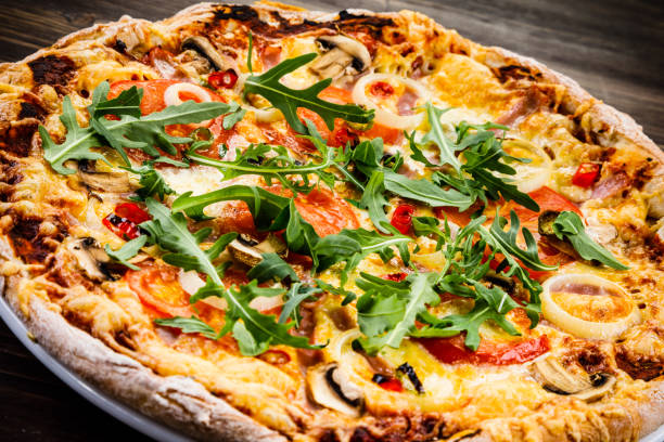 istock Pizza pepperoni on wooden background 1014709250