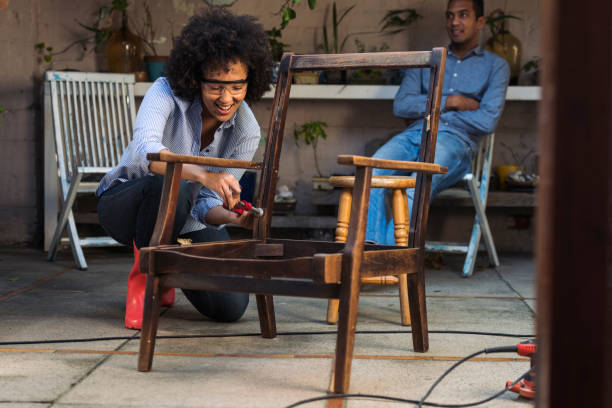 istock Smiling young woman sanding a chair 1014709442