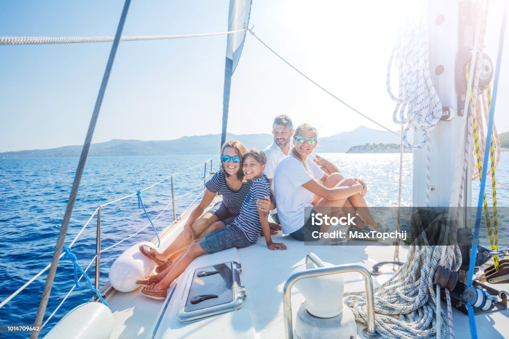 Family with adorable kids resting on yacht Happy family with adorable daughter and son resting on a big yacht Family Stock Photo