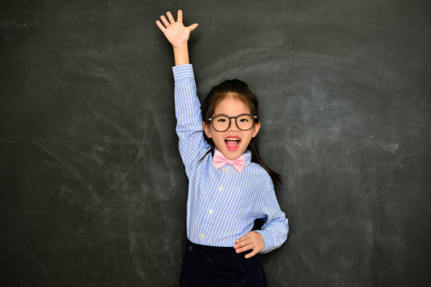 istock happy female children hand up to ask question 1014716496