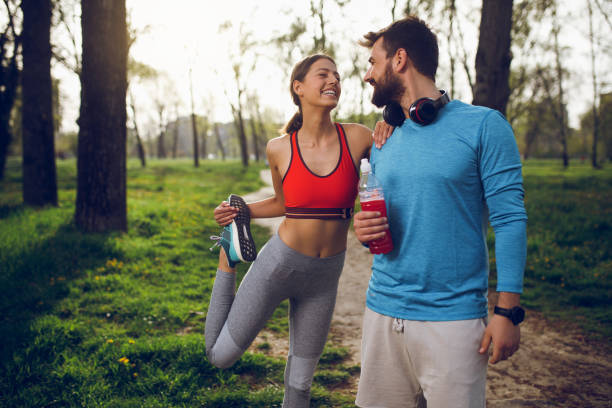 istock Fit athlete couple doing stretching exercises on running track 1014716734