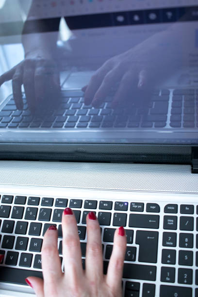 istock Secretary typist typing on laptop computer keyboard 1014716762