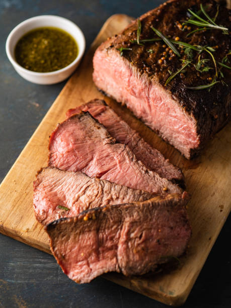 istock Sliced Roast beef on cutting board with grilled vegetables . 1014721732