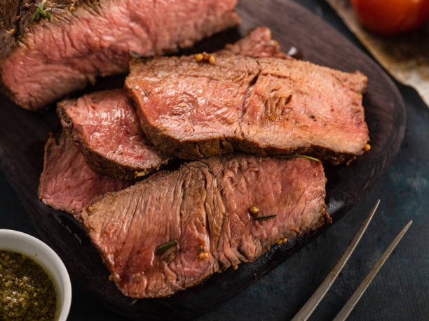 istock Sliced Roast beef on cutting board with grilled vegetables . 1014721968