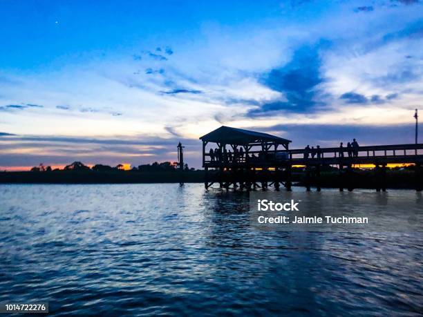 People Walking On A Pier At Sunset Stock Photo - Download Image Now - South Carolina, Charleston - South Carolina, Mount Pleasant - South Carolina