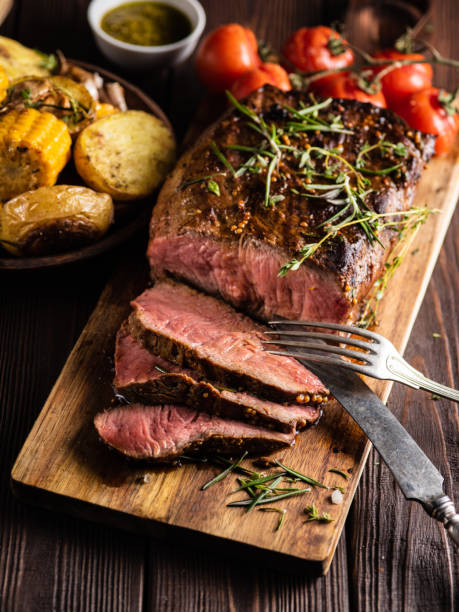 istock Sliced Roast beef on cutting board with grilled vegetables . 1014728920