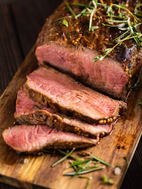 istock Sliced Roast beef on cutting board with grilled vegetables . 1014729146