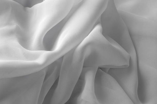 istock Texture, background, pattern. Silk fabric of white color, abstract folds. 1014737020