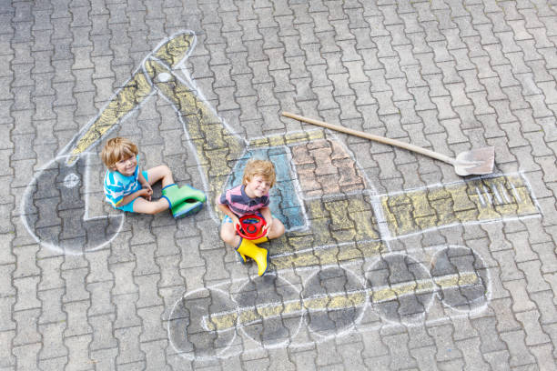 istock Two little kid boys with excavator chalk picture 1014737248