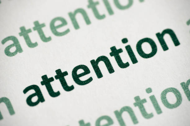 istock word attention printed on paper macro 1014737426
