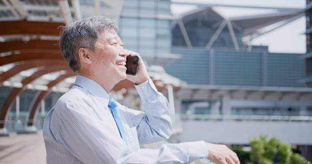 istock old businessman speak phone 1014737434