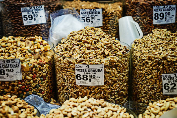 Shot of containers filled with different types of nuts and put on display to be sold at a market during the day