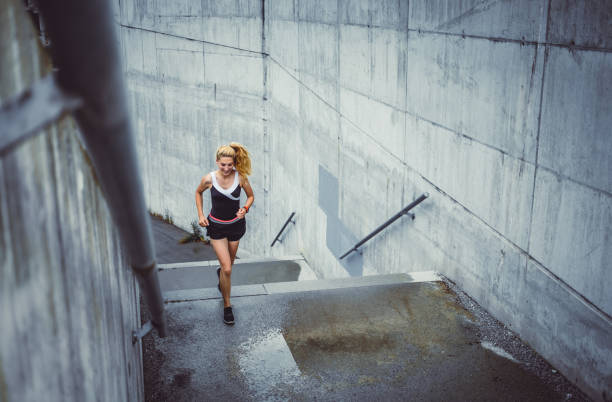 istock Female Athlete Running on The Staircase 1014737714