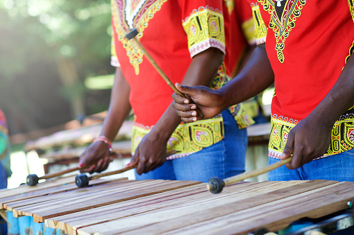 Traditional African Marimba player hands playing Wooden Xylophone Outdoors
