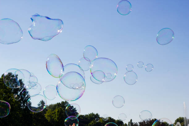 istock Many large soap bubbles flying in blue sky 1014753880