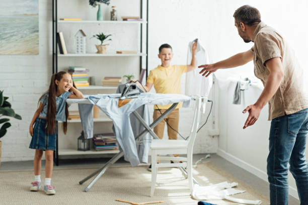 istock disobedient children burning clothes with iron at home, parenthood concept 1014757326