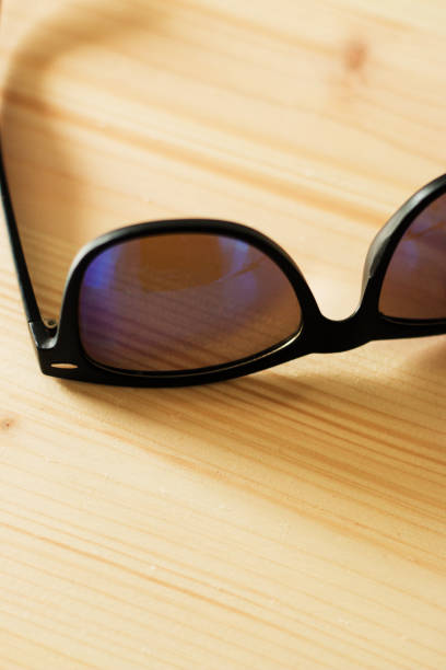 istock Black man sun glasses on wooden background 1014757412