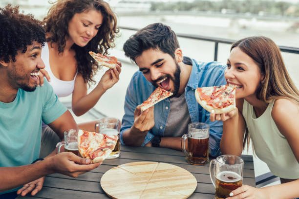 istock Friends enjoying pizza. 1014758604