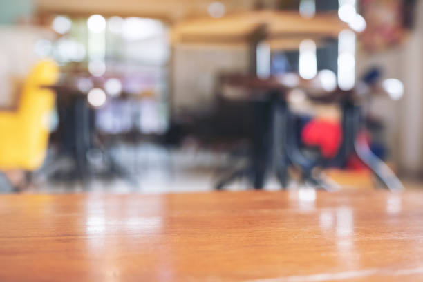istock Wooden table in modern cafe with blur bokeh vintage background 1014760784