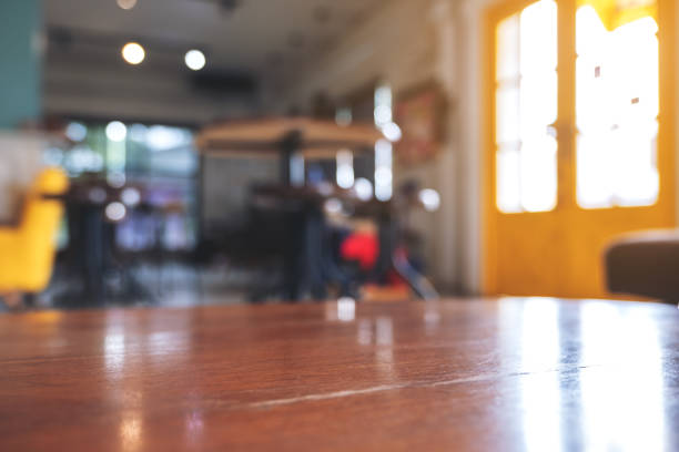 istock Wooden table in modern cafe with blur bokeh vintage background 1014760790