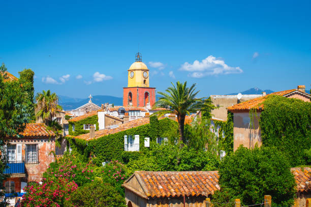 St Tropez, French Riviera. Old town with bell tower. Bell tower of church in old town of Saint Tropez. Travel image with blue sky and bright colors. france village blue sky stock pictures, royalty-free photos & images