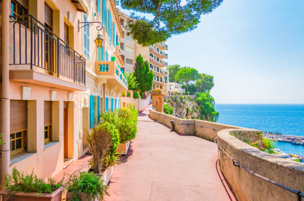 Monaco, Monte carlo. Monaco village with colorful architecture and street along the ocean. Typical walking street with colorful houses along the seaside of Monaco. monte carlo stock pictures, royalty-free photos & images