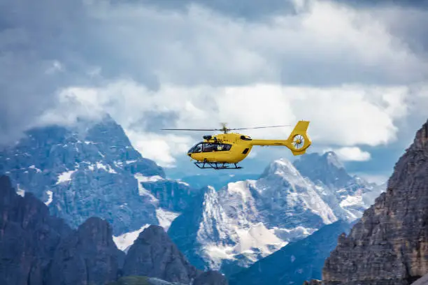Panoramic flight over the mountains. Air transport. Helicopter flight over the epic landscape. Rescue mission in the wilderness.