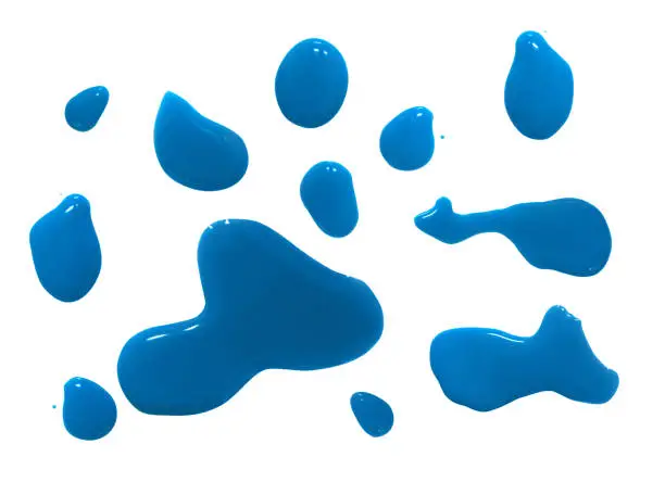 Photo of Spilled blue watercolor puddle isolated on white background from top view