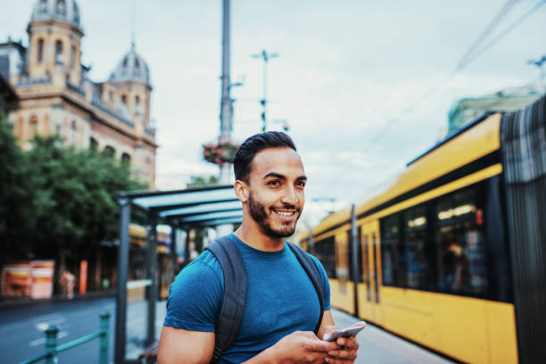 istock Young entrepreneur using mobile app to see the tram schedule 1014767436