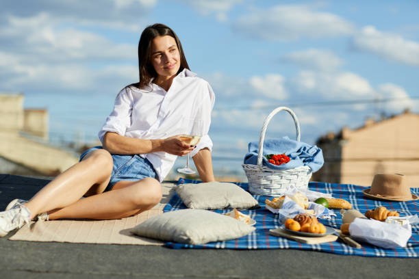istock Pensive lady drinking wine on city roof 1014767652