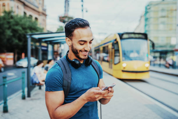 istock Young entrepreneur using mobile app to see the tram schedule 1014770344