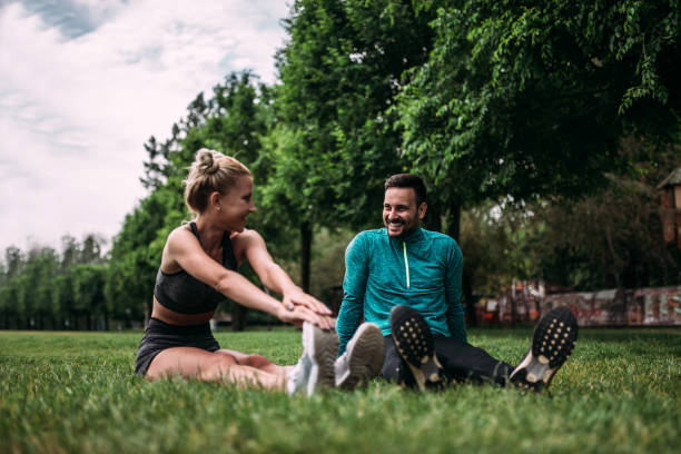 istock Athletic couple doing stretch exercise in the park. 1014770820