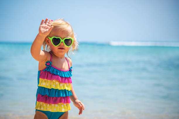 istock Cute little blond girl on the beach 1014784240