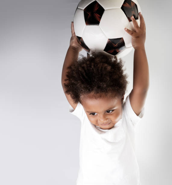 istock Cute little goalkeeper with soccer ball 1014785004
