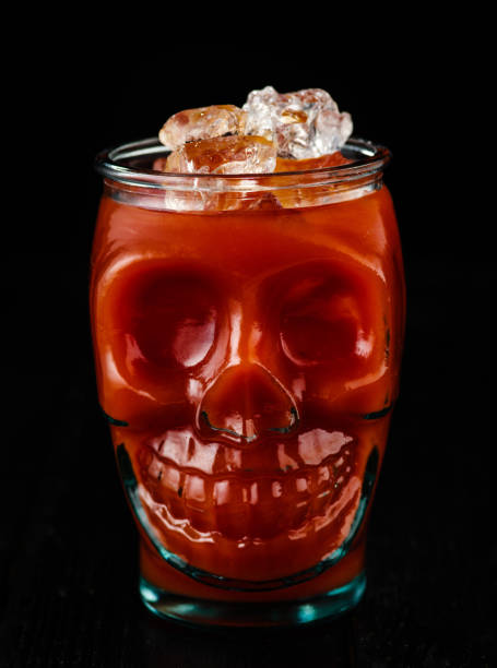 traditional cocktail bloody mary with ice in a skull glass on black table. - 4605 imagens e fotografias de stock