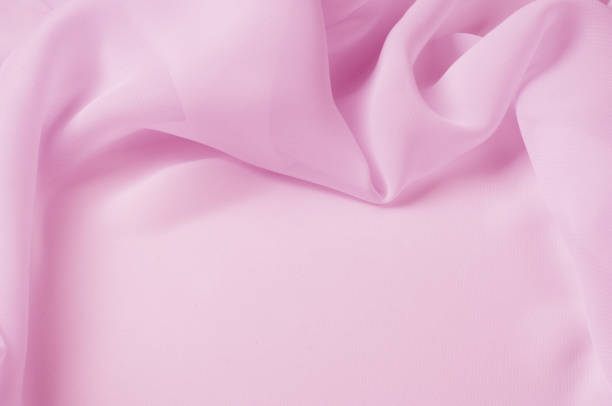 istock Texture, background, pattern. Silk fabric pale pink, abstract folds 1014792862