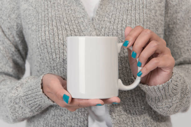 istock Hand Holding White coffee cup. mockup for creative design branding. 1014795928