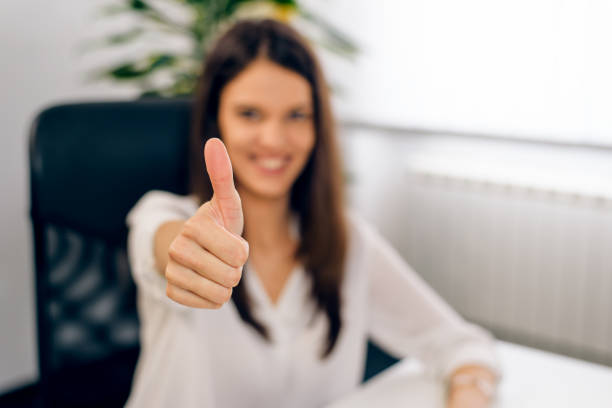istock Smiling successful woman giving a thumbs up 1014801540