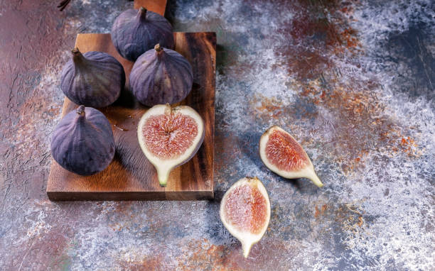 istock Ripe figs on a cutting board on a metal background. Close-up. 1014802222