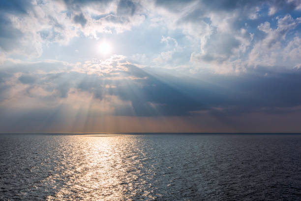 istock Beautiful landscape with dramatic clouds, sun and sea 1014805808