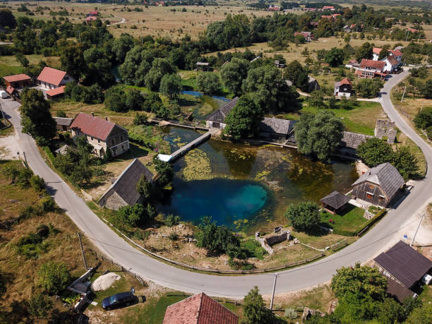 istock gacka, lika, croatia, river, water, old, source, landscape, wooden, countryside, nature, spring, tree, environment, rural, scenery, village, architecture, traditional, house, peaceful, cottage, view, beautiful, sky, outdoor, park, scenic, country, lake, 1014806994